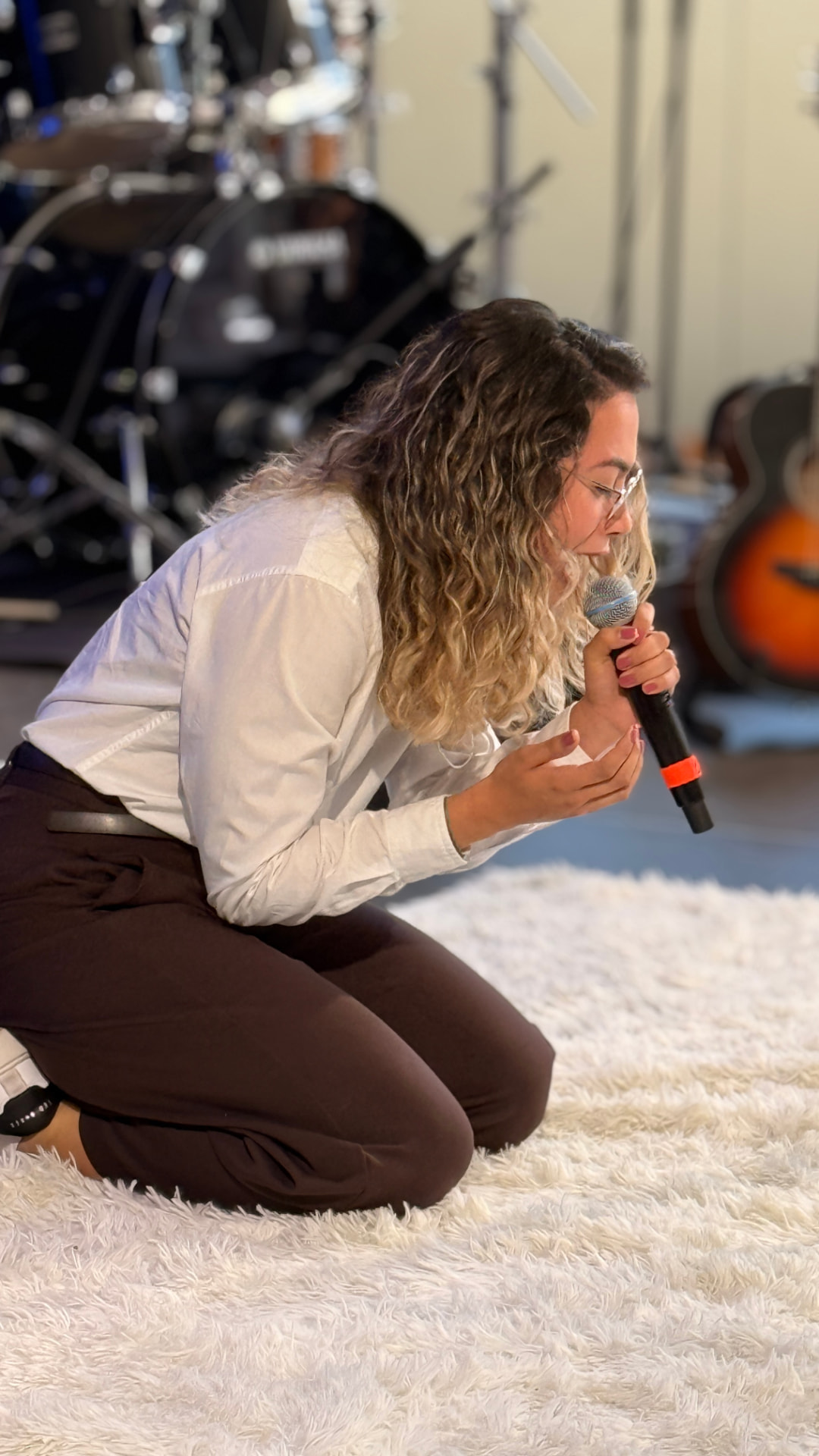 Mulher cantando em adoração de joelhos